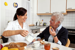 caregiver assisting old woman